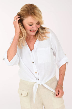 Woman wearing a white button down and beige pants