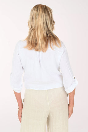 Woman wearing a white button down and beige pants
