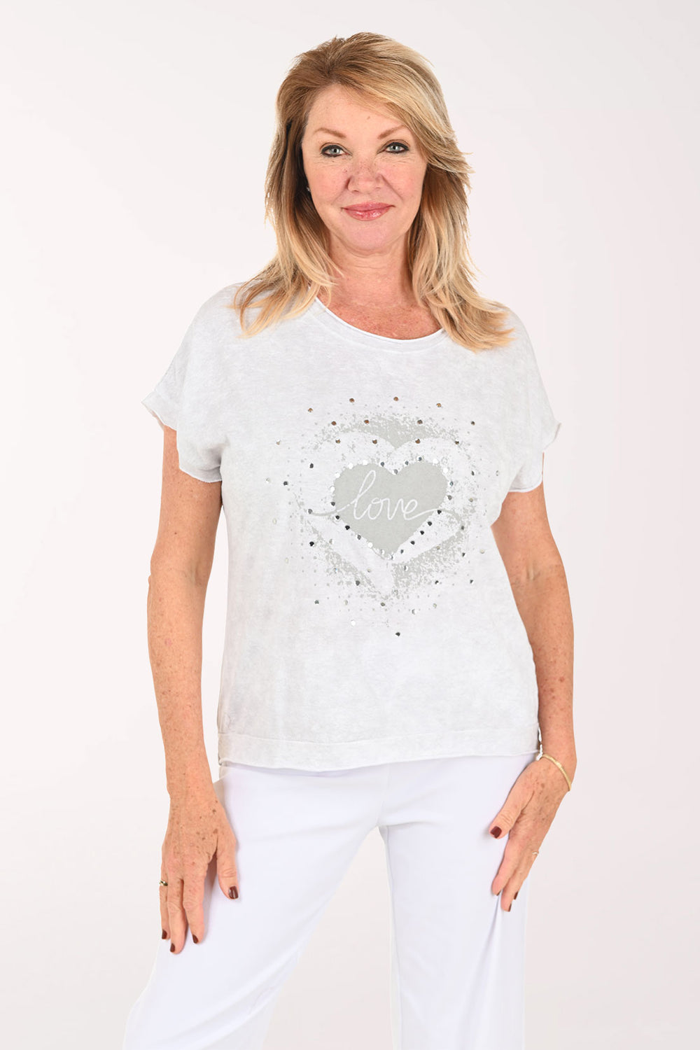 Woman wearing a short sleeve grey tee with the word 'love' on it