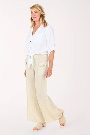 Woman wearing a white button down top and beige pants