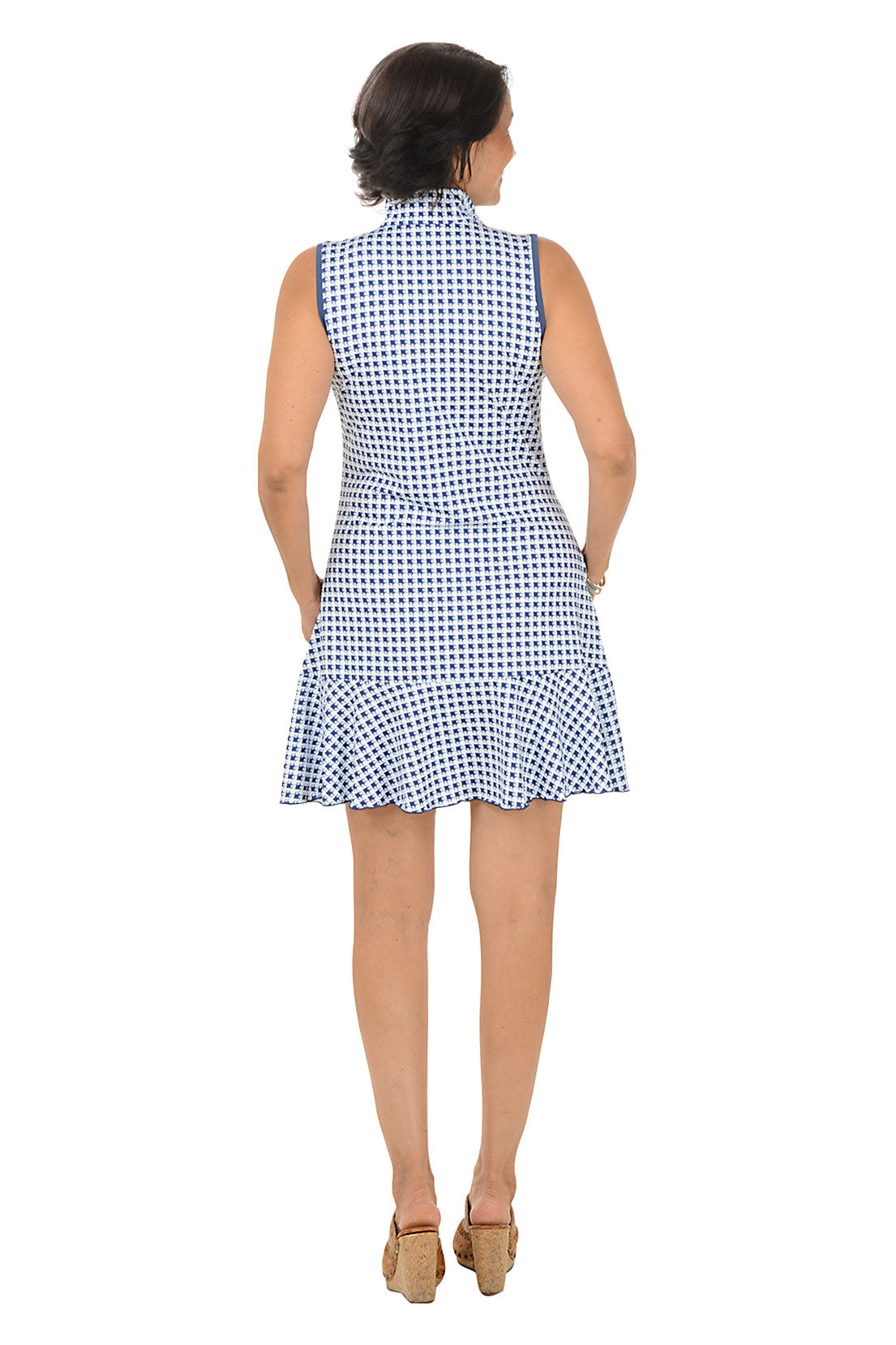Woman wearing a blue and white checkered dress on a white background