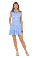 Woman wearing a blue patterned dress on a white background