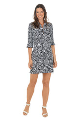 Woman wearing a black and white patterned dress on a white background