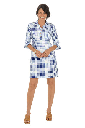 Woman wearing a blue and white checkered dress on a white background