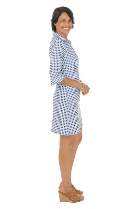 Woman wearing a blue and white checkered dress on a white background
