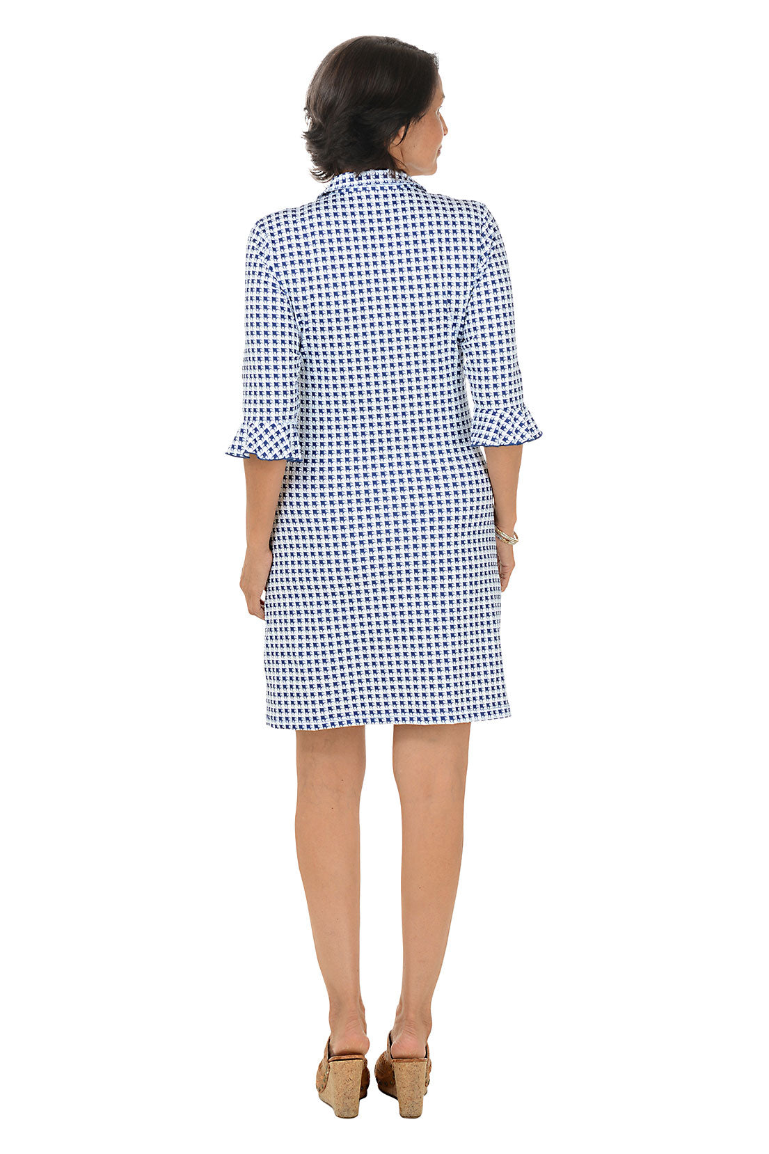 Woman wearing a blue and white checkered dress on a white background
