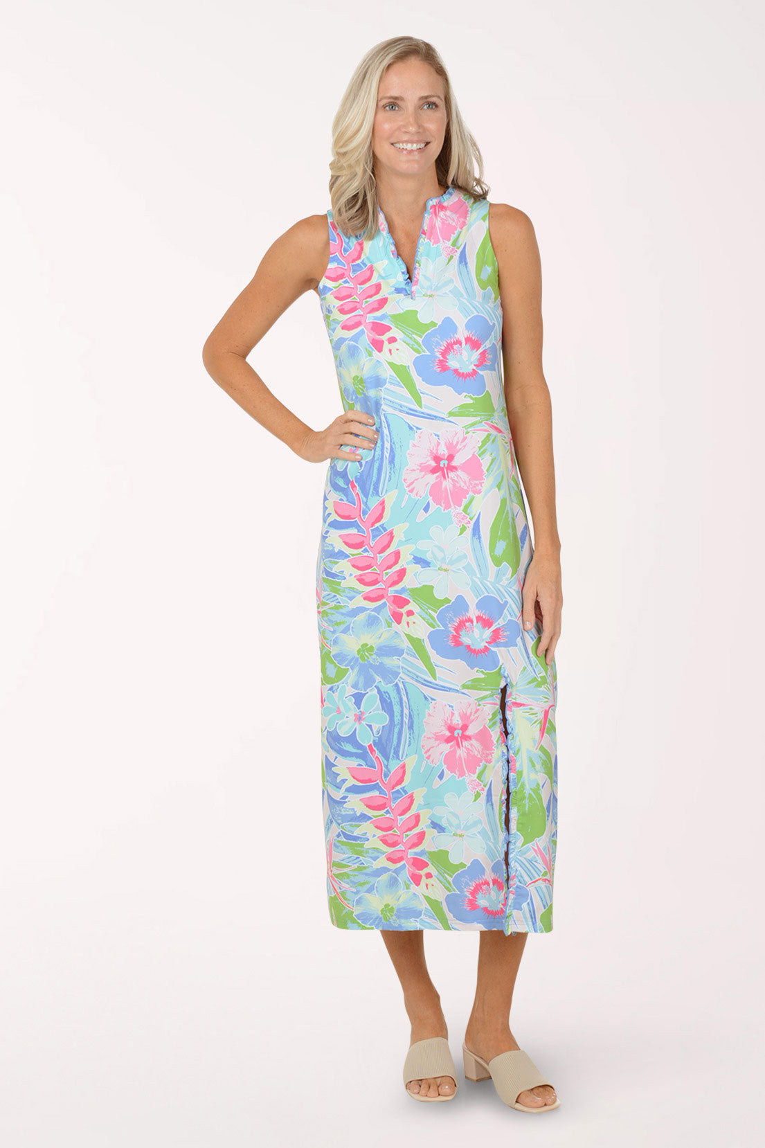 Woman wearing a colorful floral maxi dress on a white background