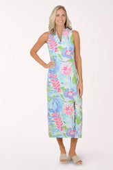Woman wearing a colorful floral maxi dress on a white background