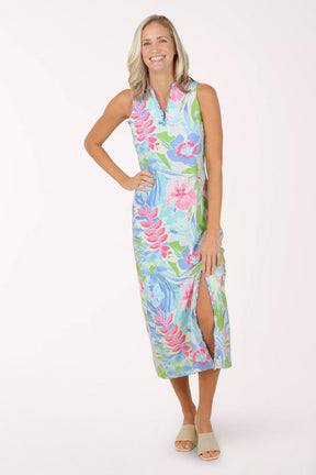 Woman wearing a colorful floral maxi dress on a white background