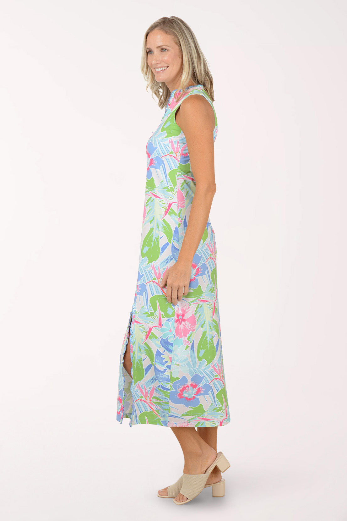 Woman wearing a colorful floral maxi dress on a white background