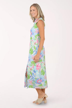 Woman wearing a colorful floral maxi dress on a white background