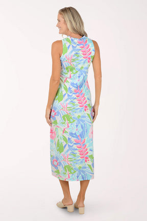 Woman wearing a colorful floral maxi dress on a white background