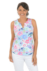 Woman wearing a colorful floral sleeveless top on a white background