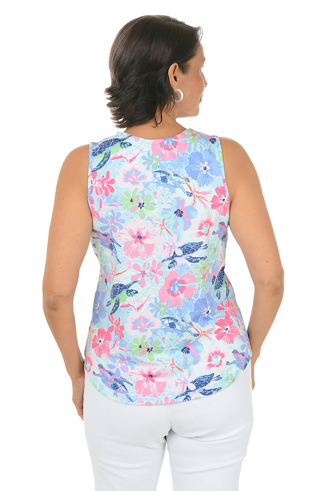 Woman wearing a sleeveless floral top with a white background