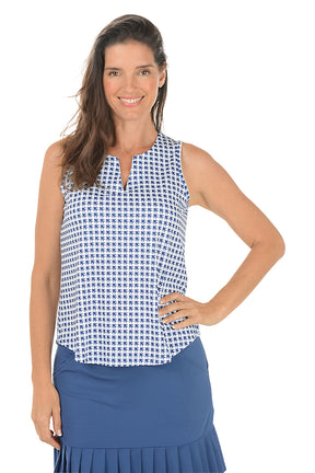 Woman wearing a sleeveless patterned top and blue skirt on a white background