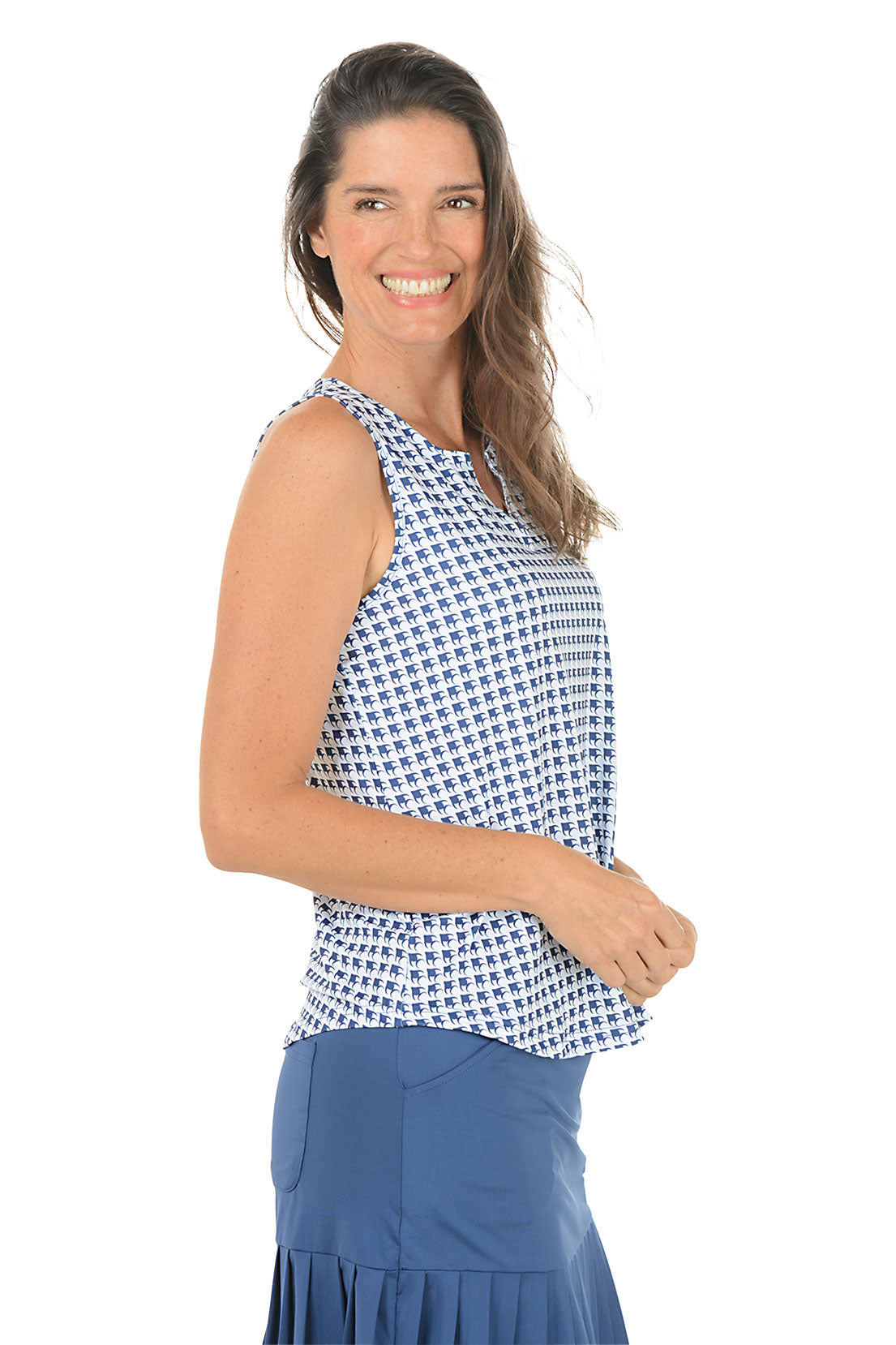 Woman wearing a sleeveless patterned top and blue skirt on a white background