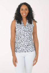 Woman wearing a sleeveless animal print top and white pants on a white background