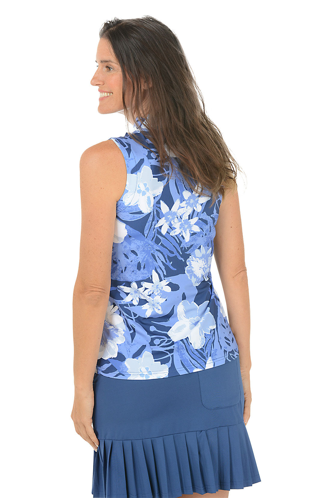 Woman wearing a blue floral sleeveless top and skirt on a white background. Back shot.