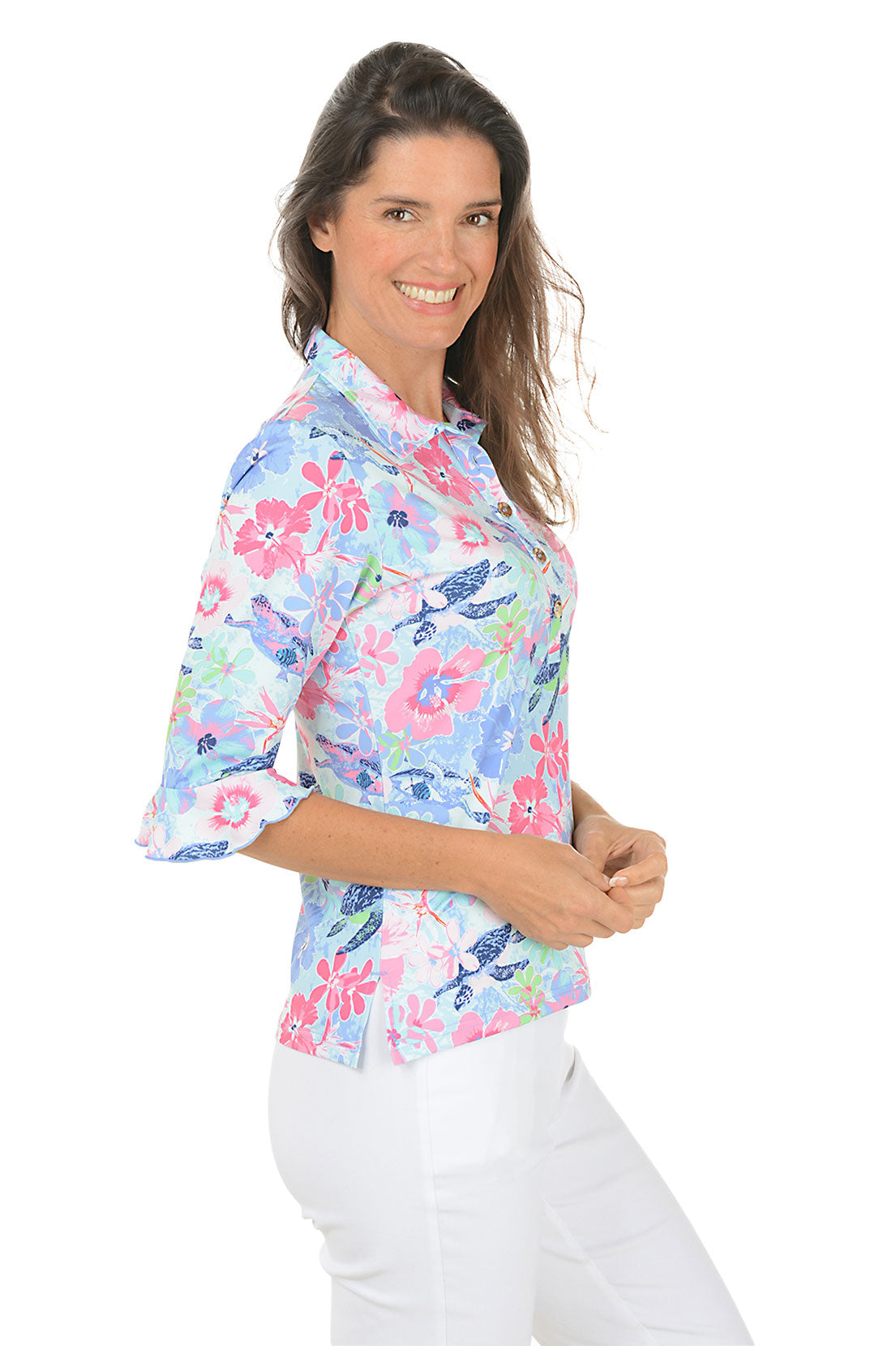 Woman wearing a colorful floral shirt with a white background