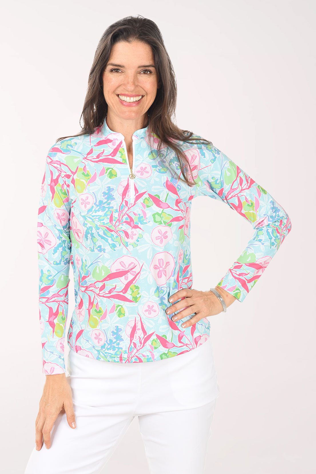 Woman wearing a colorful floral patterned shirt on a white background