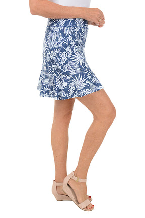 Person wearing a blue floral skirt on a white background