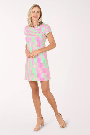 Woman wearing a pink checkered dress on a white background