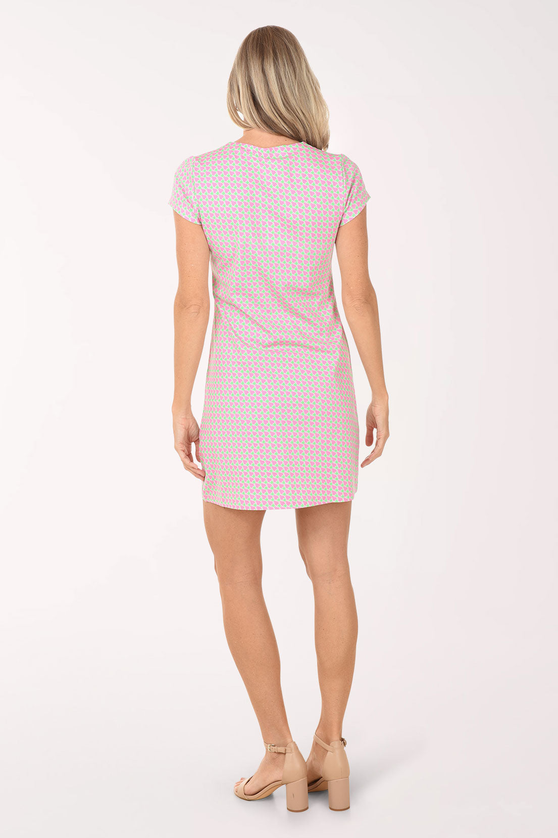 Woman wearing a pink checkered dress on a white background