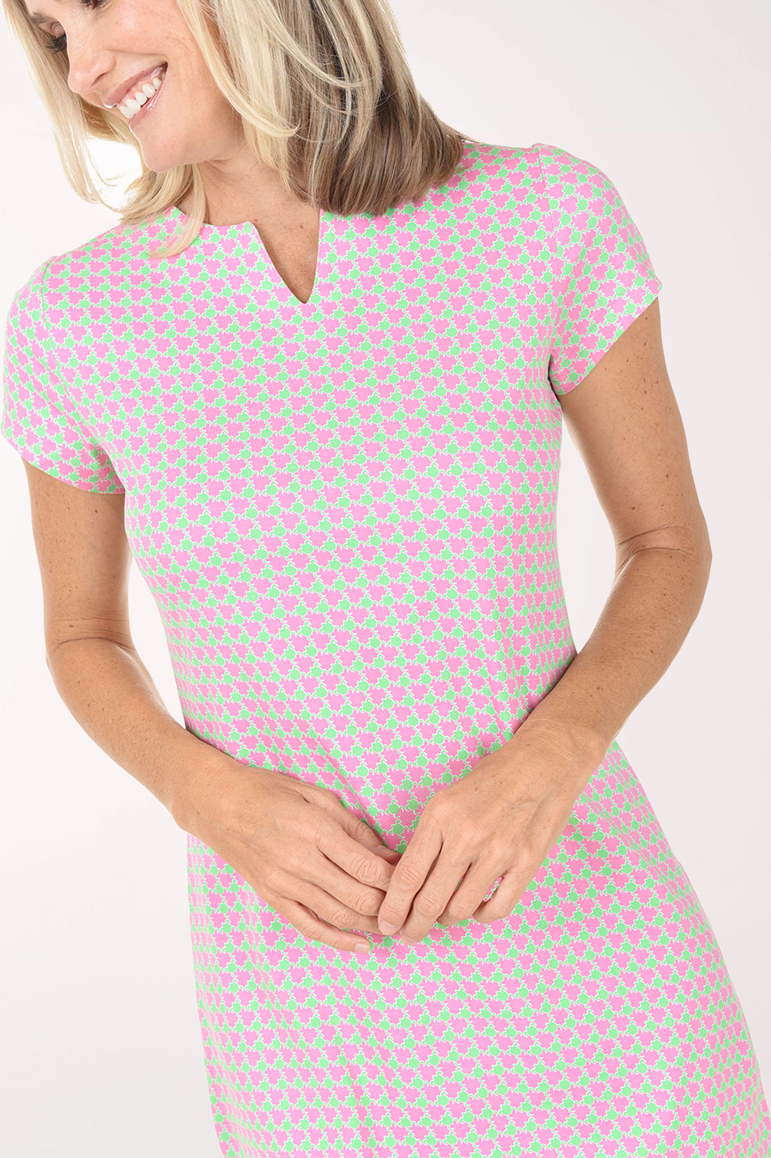 Woman wearing a pink checkered dress on a white background