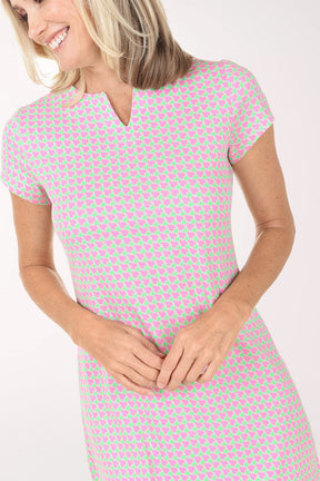 Woman wearing a pink checkered dress on a white background