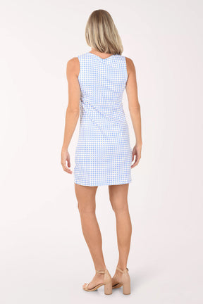 Woman wearing a light blue checkered dress on a white background