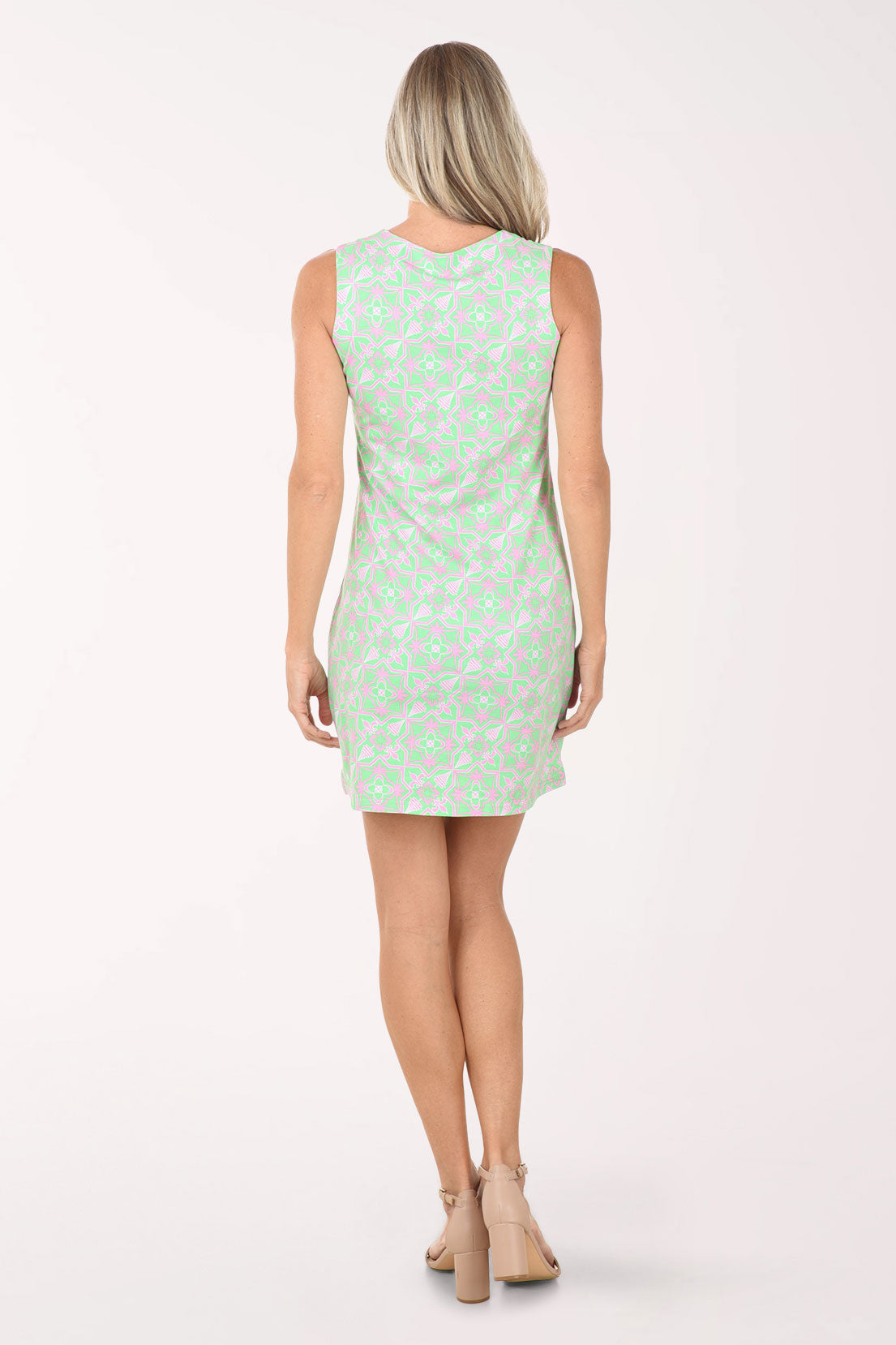 Woman wearing a light green dress with a subtle pattern on a white background