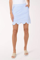 Person wearing a blue and white checkered skirt on a white background