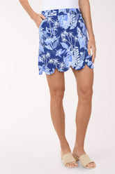Person wearing a blue floral skirt on a white background