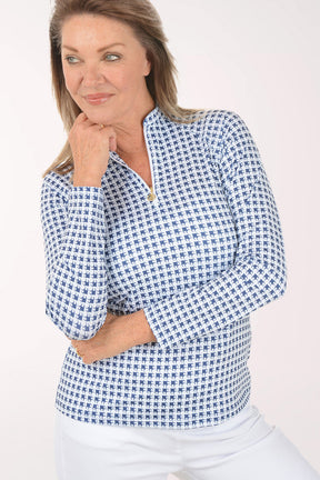 Woman wearing a blue checkered shirt against a white background