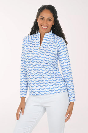 Woman wearing a blue and white patterned long-sleeve shirt on a white background