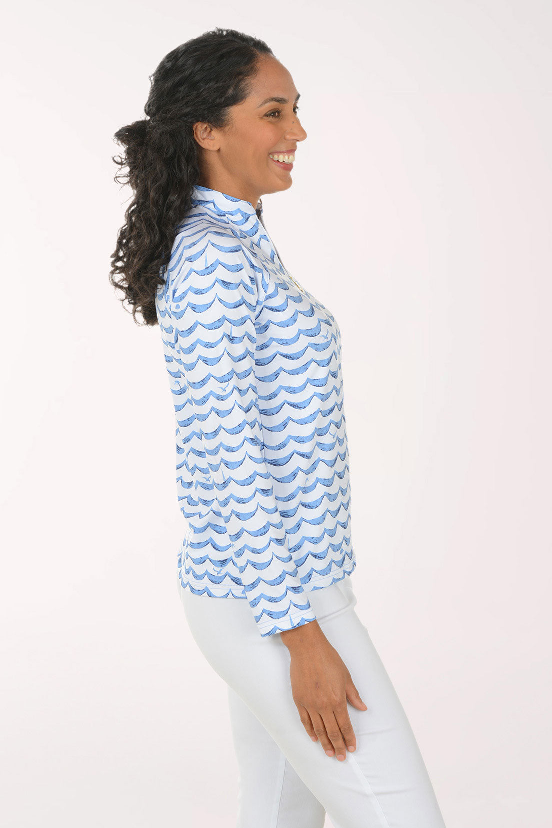 Woman wearing a blue and white patterned long-sleeve shirt on a white background