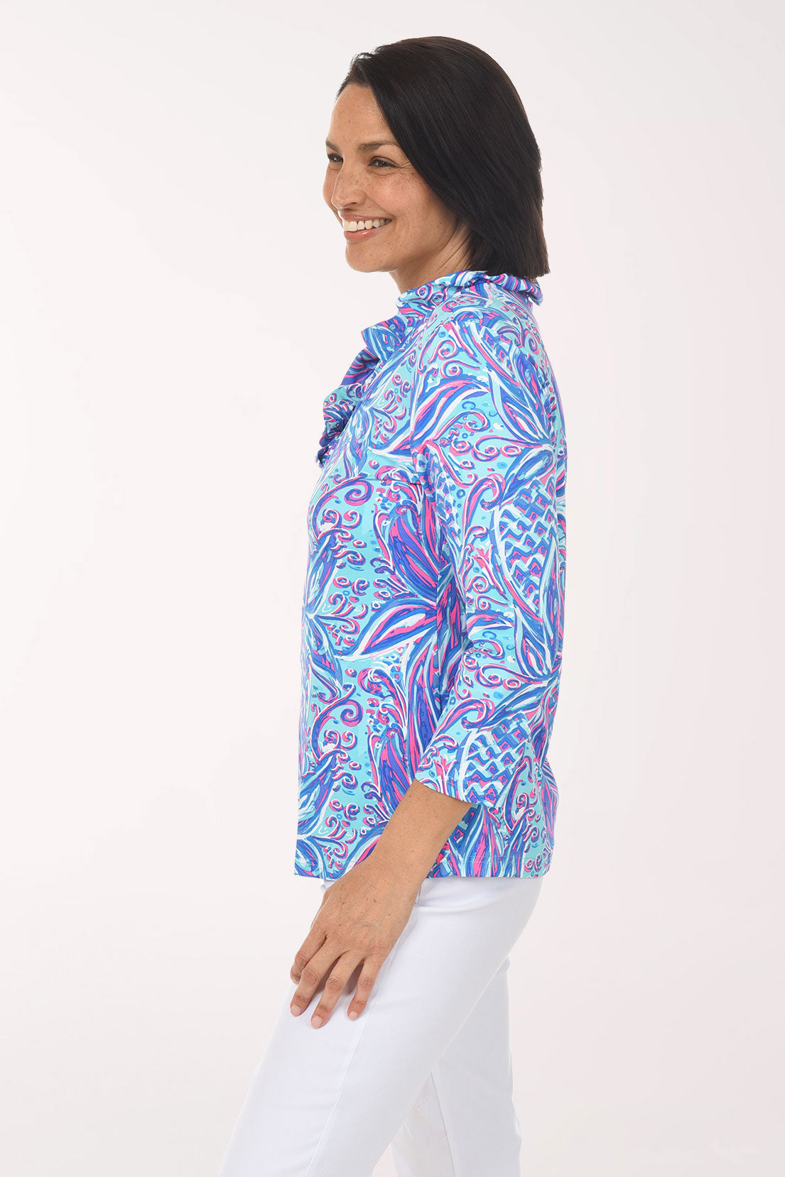 Woman wearing a colorful patterned blouse on a white background