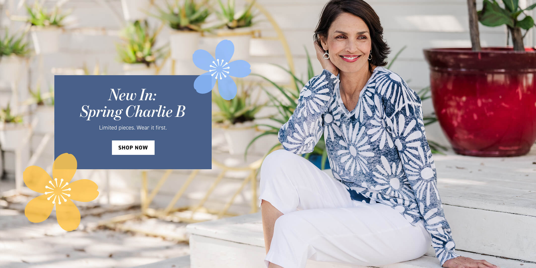 Woman sitting on a steps with a promotional banner for 'Spring Charlie B' clothing line.