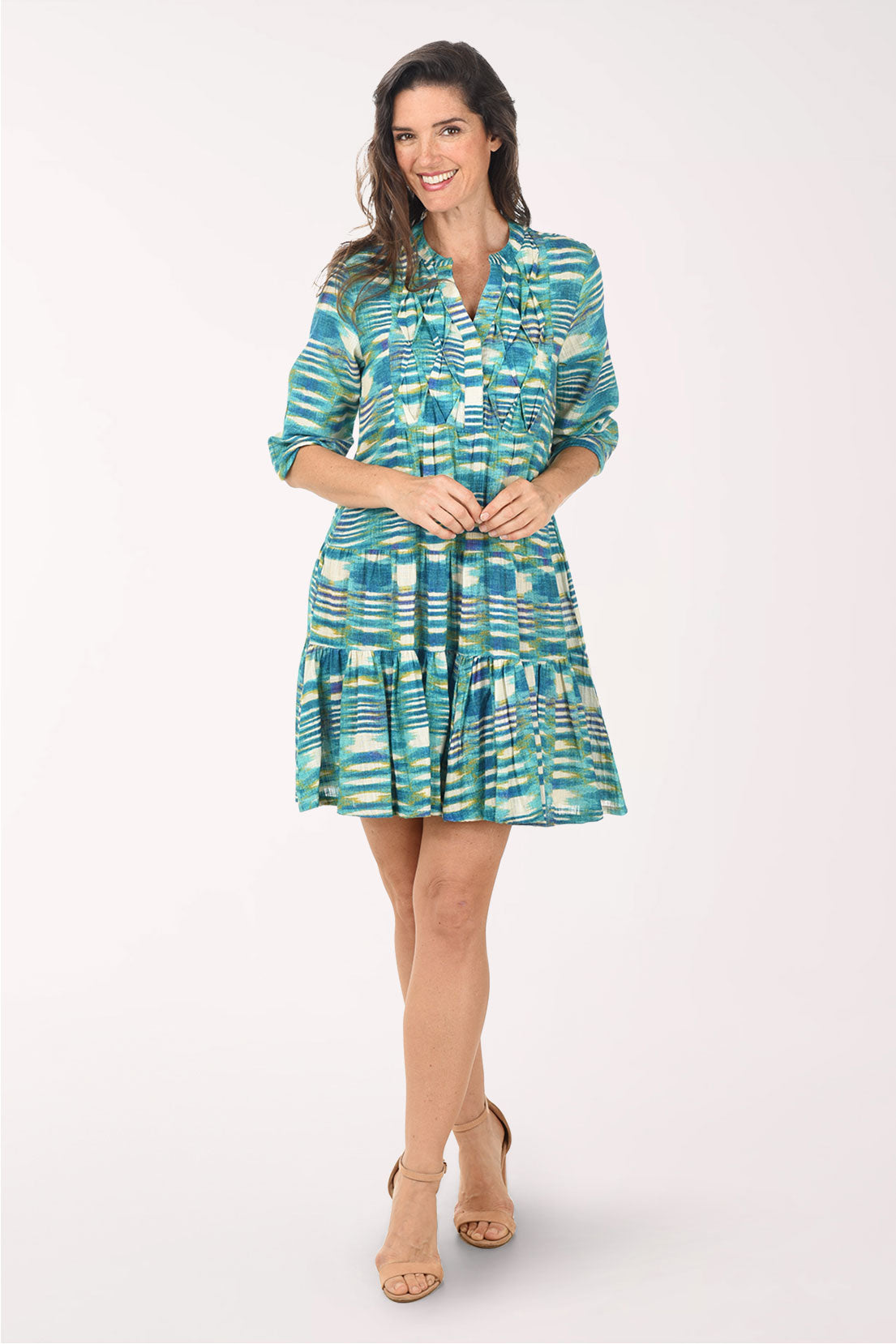 Woman wearing a patterned dress on a white background