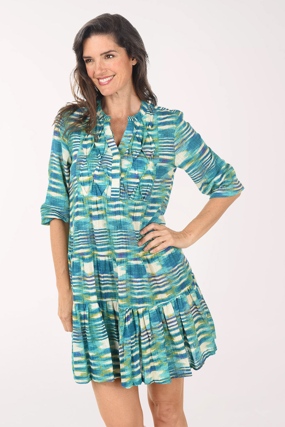 Woman wearing a patterned dress on a white background