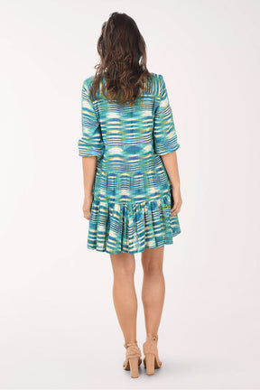 Woman wearing a patterned dress on a white background