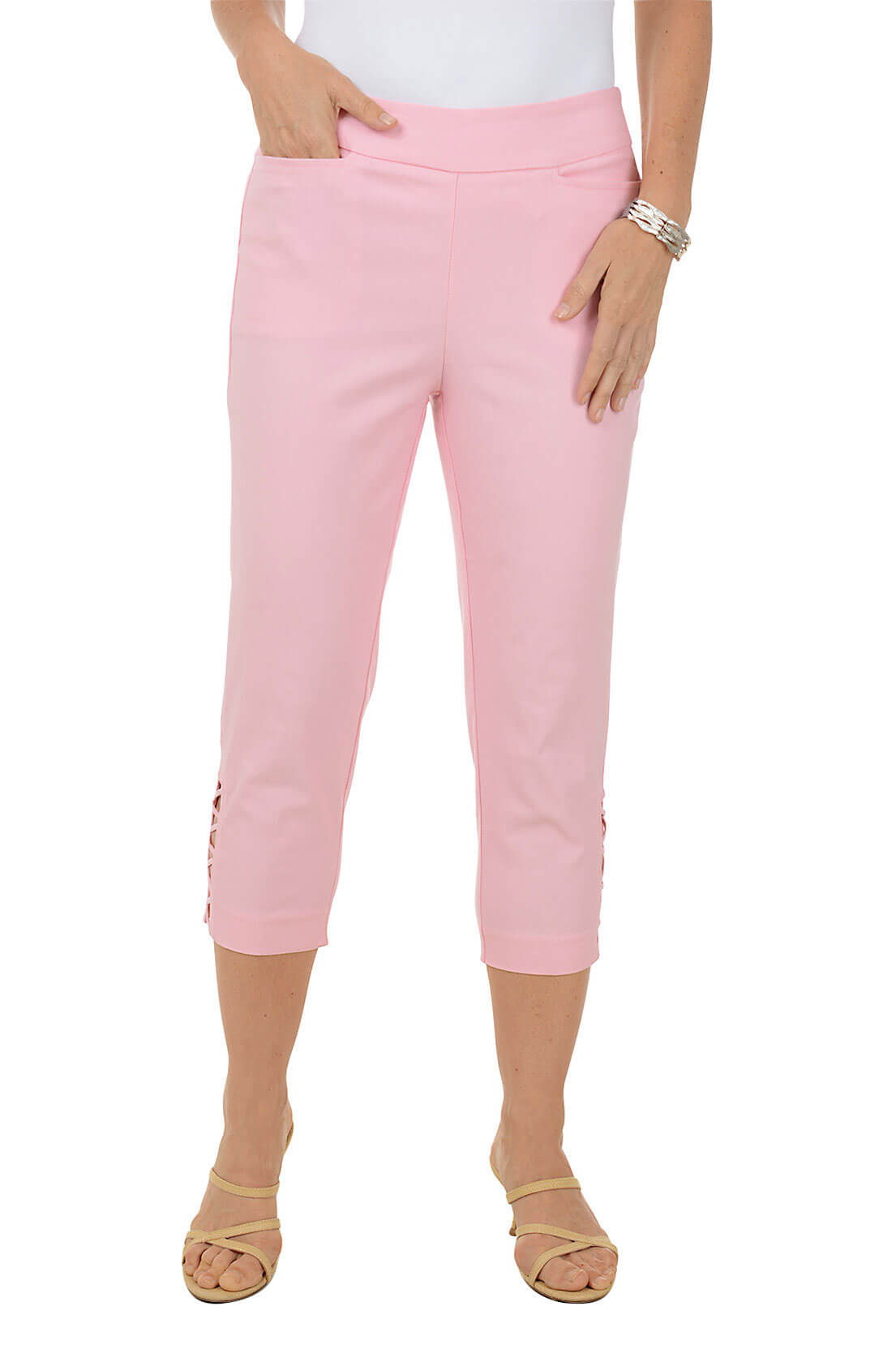 Pink capri pants worn by a person on a white background