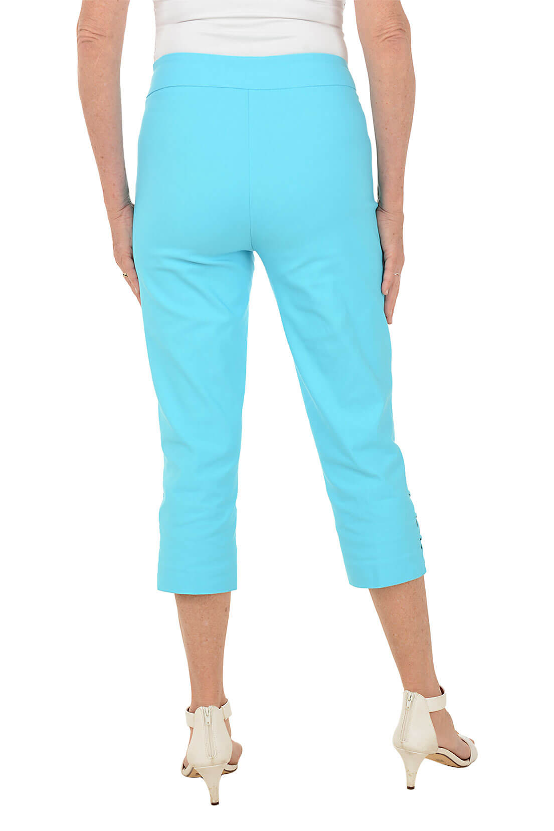 Person wearing light blue capri pants on a white background. Back shot.