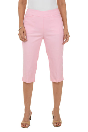 Person wearing pink clamdigger pants on a white background