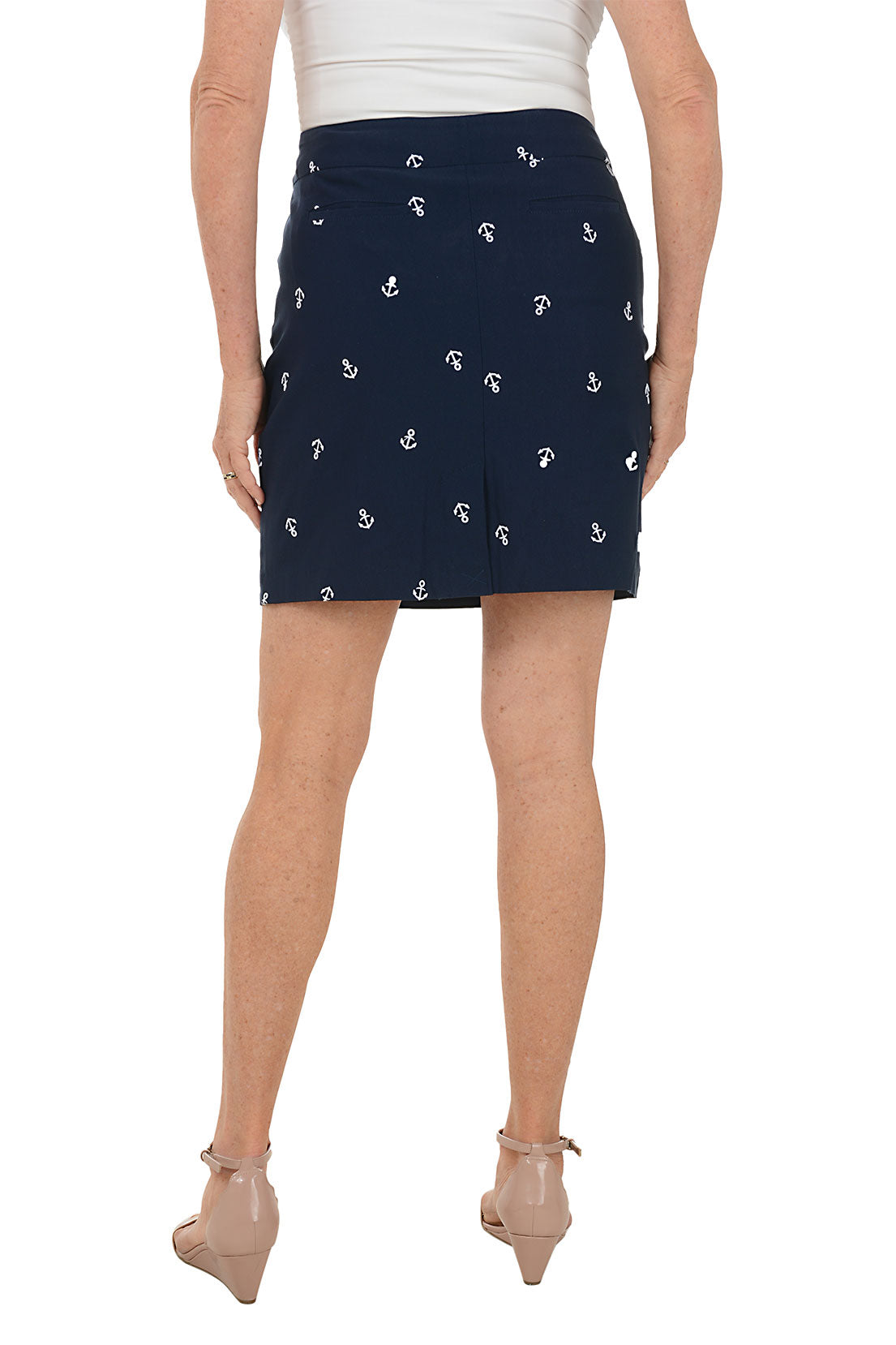 Navy blue skirt with white anchor pattern worn by a person on a white background. Back shot.