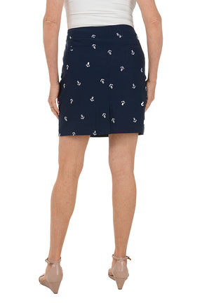 Navy blue skirt with white anchor pattern worn by a person on a white background. Back shot.
