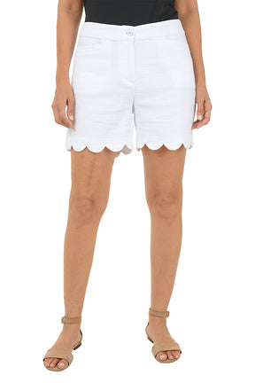 White shorts with scalloped edges worn by a person on a white background.
