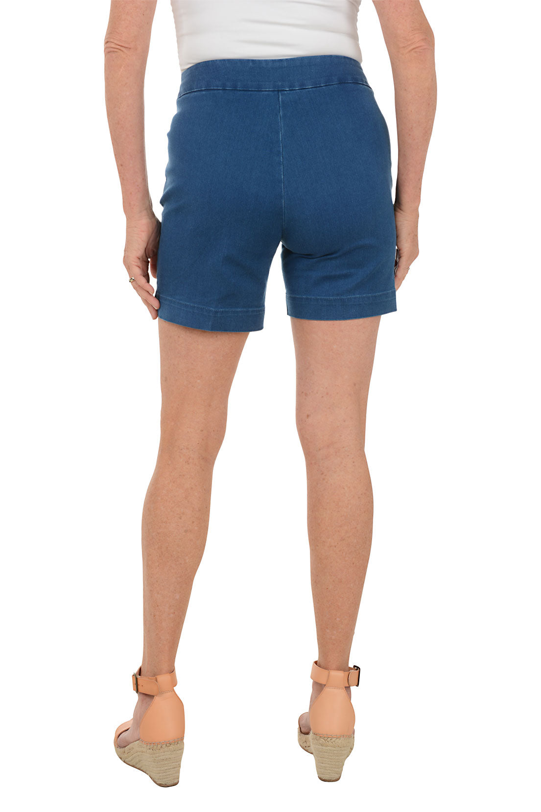 Person wearing blue shorts on a white background. Back shot.