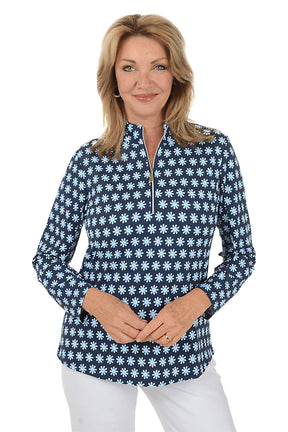 Woman wearing a navy blue floral patterned shirt on a white background