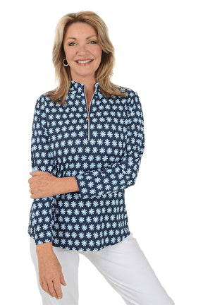 Woman wearing a navy blue floral patterned shirt on a white background